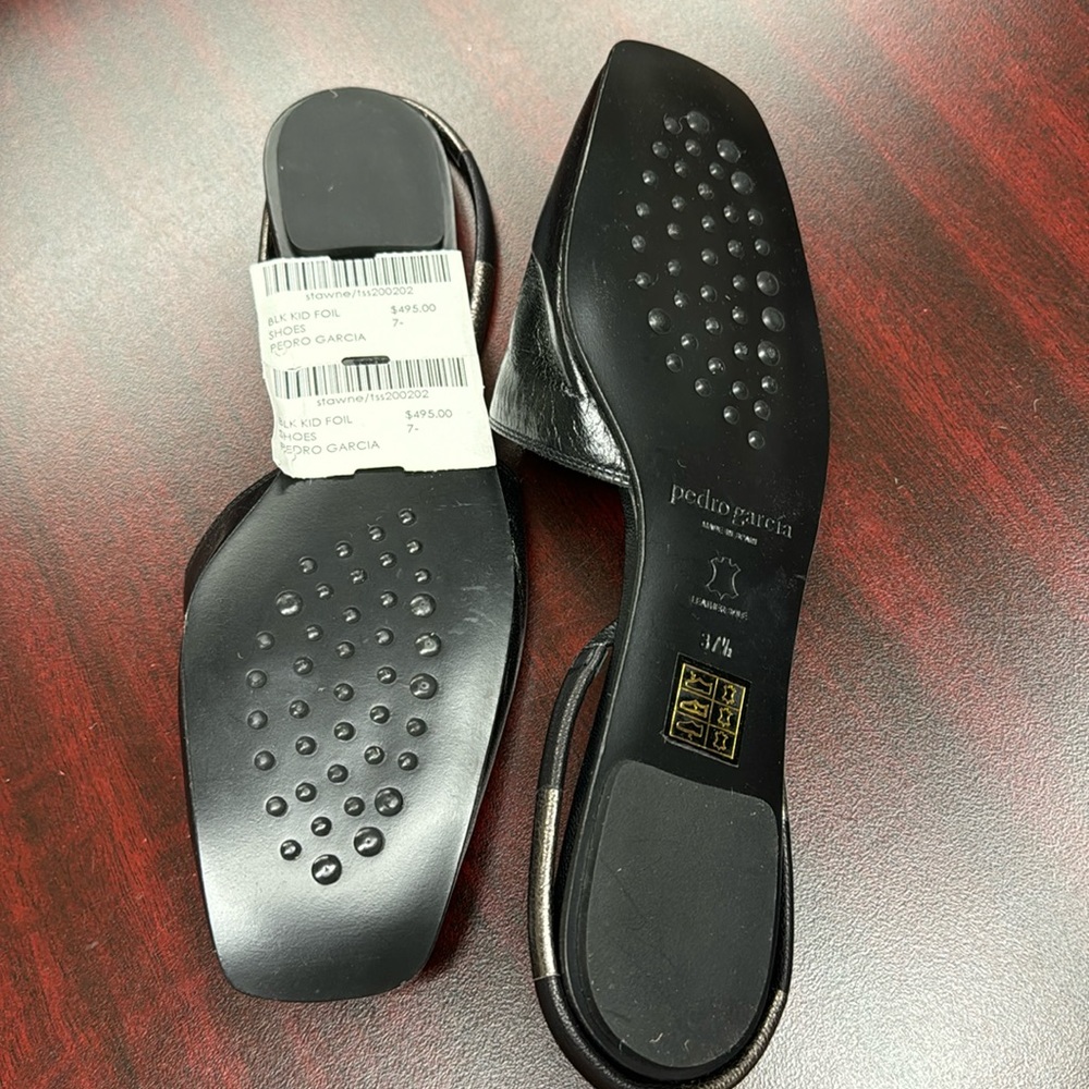 Black leather sling back flats.